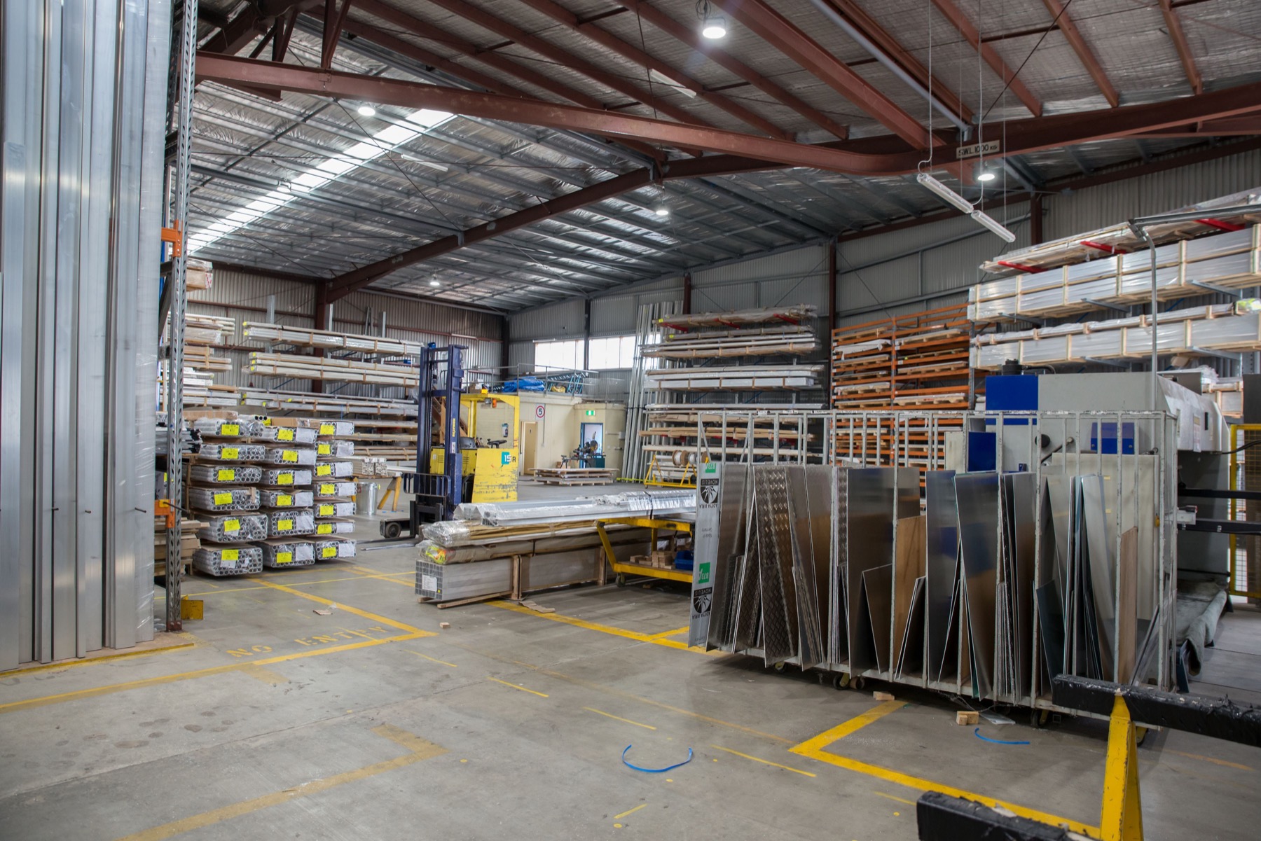 A warehouse interior with industrial materials and storage racks.